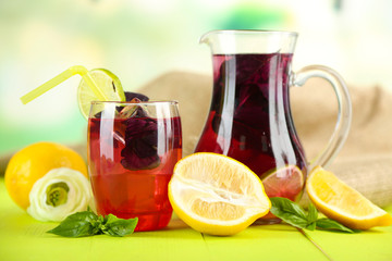 Red basil lemonade in jug and glass,
