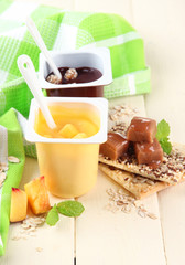 Tasty   cream desserts with pieces of fresh fruits, cookies and