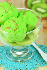 Delicious ice cream on glass vase on wooden table close-up