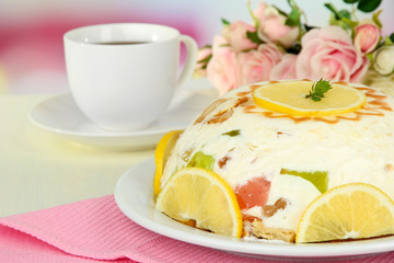 Delicious jelly cake on table on light background