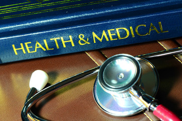 Stethoscope and medical text book on the doctor's desk.