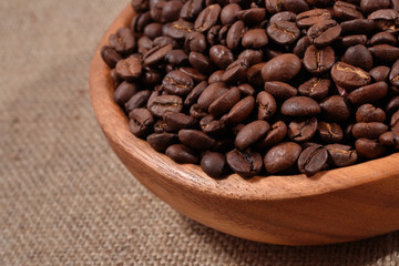 Coffee beans in a wooden bowl