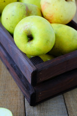 green apples in a wooden crate