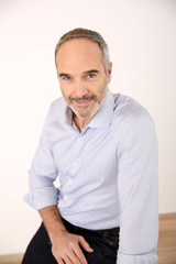 Attractive senior businessman sitting at table