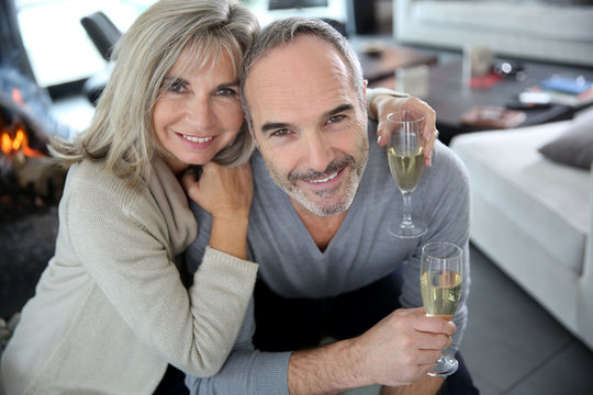 Happy Senior Couple Enjoying Glass Of Champagne