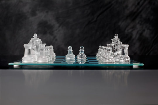 glass chess board with chess pieces