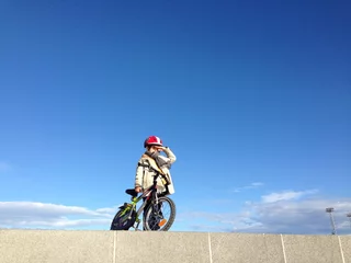 Foto op Plexiglas boy with a bicycle looking far ahead © ladybirdstudio