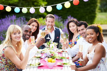 Group Of Friends Enjoying Outdoor Dinner Party