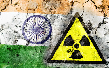 Old cracked wall with radiation warning sign and painted flag
