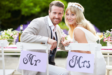 Bride And Groom Enjoying Meal At Wedding Reception