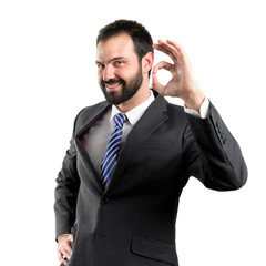businessman making an OK gesture over isolated white background