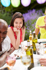 Young Woman Relaxing At Outdoor Barbeque