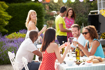 Group Of Friends Having Outdoor Barbeque At Home