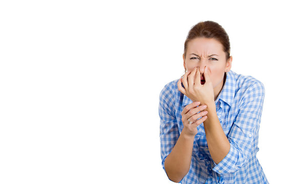 Woman covers her nose, can't breath, something stinks