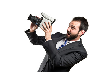 Young businessman recording video over white background