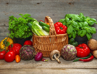 fresh vegetables and herbs on wooden background