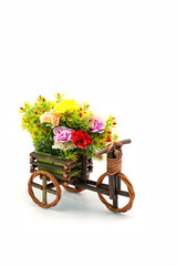 Fototapeta na wymiar Wooden bicycle with colorful flowers on white