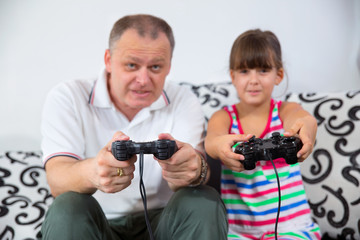 father and child playing a video game