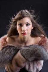Portrait of beautiful young woman in fur coat