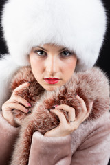 Portrait of beautiful young woman in fur hat