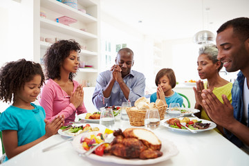 Obraz na płótnie Canvas Multi Generation African American Family Praying At Home