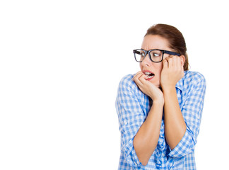 Stressed neurotic woman biting her fingernails, looking sideways