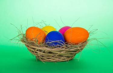 Easter eggs in a basket with hay