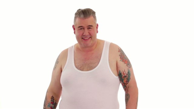 Freaky tattoed man posing and in front of a mirror.