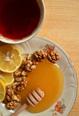 Honey with walnuts and lemon and tea