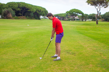 Fototapeta premium Young man playing golf