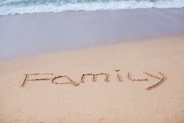 Family painted in the sand on a tropical beach