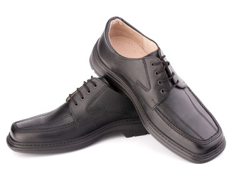 Black glossy man’s shoes with shoelaces