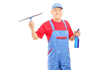 Male cleaner in uniform holding a cleaning equipment for glass