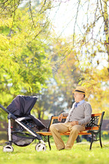 Senior man sitting on a bench and looking at his nephew in park