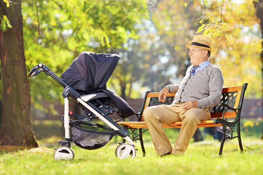 Grandfather sitting on a bench and looking at his nephew