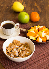 Healthy breakfast with granola, fruits, nuts and coffee.