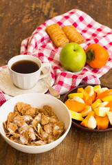 Healthy breakfast with granola, fruits, nuts and coffee.