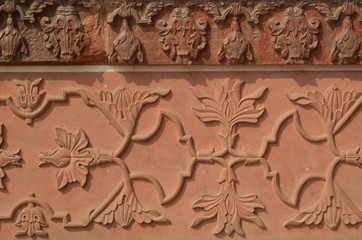 Fototapeta na wymiar Ściana z Taj Mahal z skomplikowanych wzorów w czerwonego piaskowca