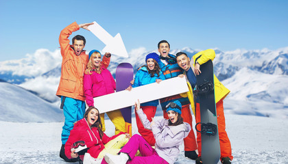 Laughing snowboarders with the mountains in the background