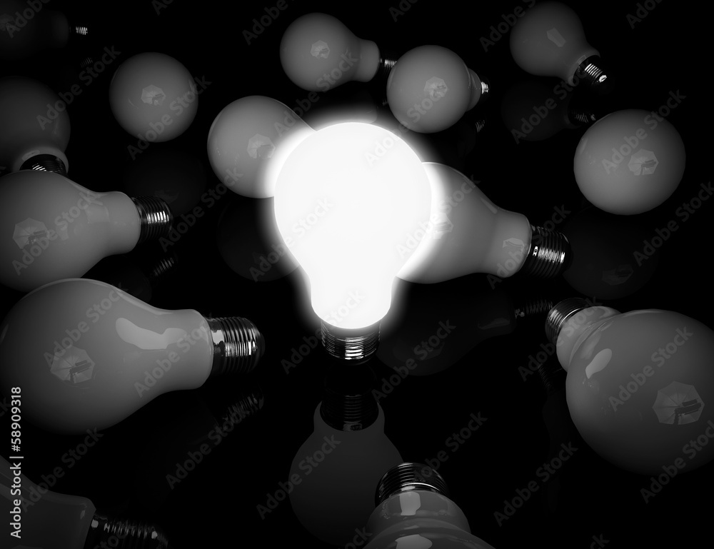 Aufkleber idea concept. one glowing light bulb standing in front of unlit