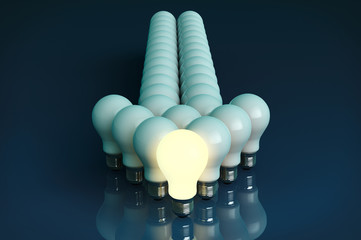 Leadership concept. One glowing light bulb standing in front of
