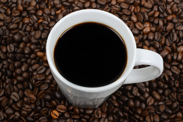 white coffee cup filled with black coffee