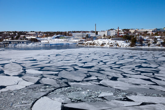 Blocks of ice on frozen sea in harbor.