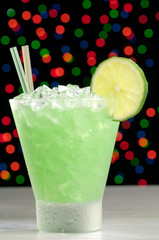 Cocktail in a frosted glass with ice and lime