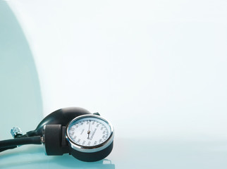 Sphygmomanometer on blue, reflective background