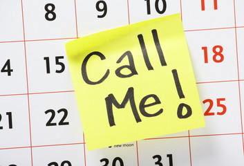 Call Me on a yellow sticky note stuck to a calendar