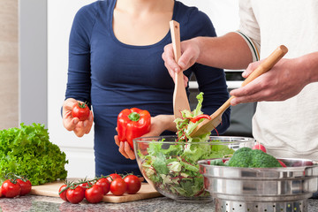 Couple cooperating in kitchen