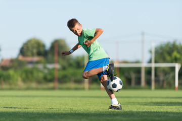 little boy running dribbling