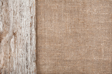 Burlap background bordered by old wood