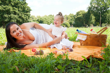 Young happy mother with daughter in the park